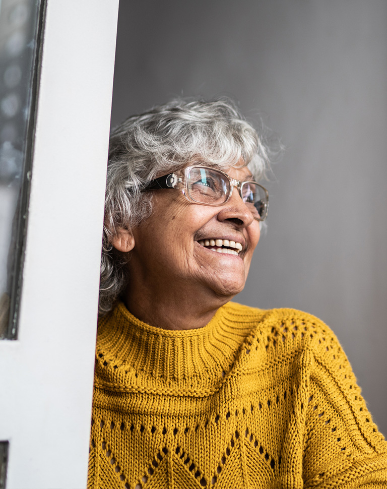 a person wearing glasses and smiling at the camera