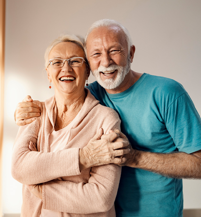 a man and a woman smiling for the camera